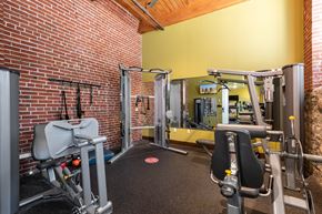 Saint Louis apartment for rent - a gym with weights and a brick wall at Lofts at Lafayette Square Apartments, Saint Louis, MO, 63104