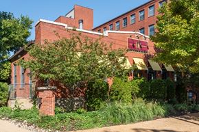 Saint Louis apartment for rent - A red brick building with a sign at Lofts at Lafayette Square Apartments, Saint Louis