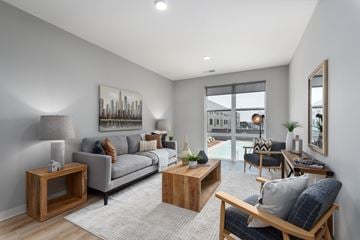 Saint Louis apartment for rent - an open living room with a couch and a table    and a patio