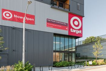 The exterior of a building with two red signs on the side of it