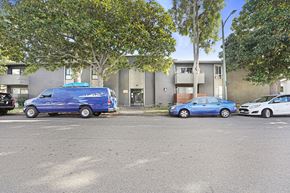 Los Angeles apartment for rent - A blue van is parked in a parking lot next to a blue car and a white car.