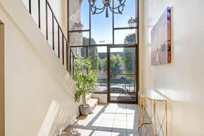 Mar Vista apartment for rent - a hallway with a staircase and a large glass door