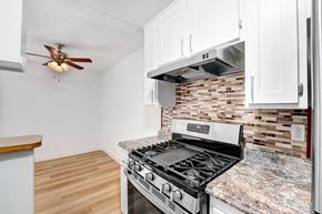 Los Angeles apartment for rent - A kitchen with a stove and a fan on the ceiling.