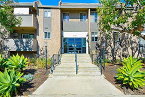 Los Angeles apartment for rent - A building with a grey facade and a glass door entrance.