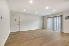 West Hollywood apartment for rent - A room with wooden flooring and white walls.