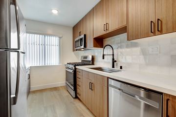 West Hollywood apartment for rent - A kitchen with wooden cabinets and stainless steel appliances.