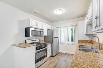 Los Angeles apartment for rent - A kitchen with a granite counter top and stainless steel appliances.