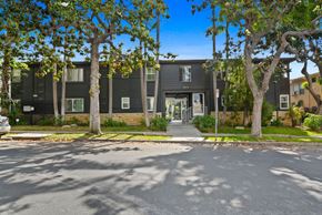 Los Angeles apartment for rent - A black building with a tree in front of it.
