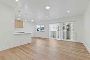 Redondo Beach apartment for rent - A room with wooden floors and white walls.