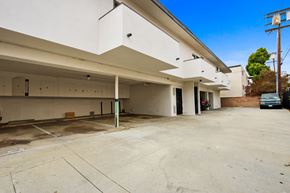Los Angeles apartment for rent - A large, empty parking garage with a clear blue sky above.