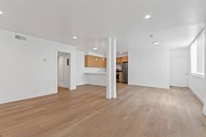 Santa Monica apartment for rent - A spacious room with wooden flooring and white walls.