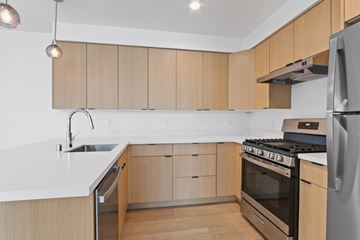 Santa Monica apartment for rent - A modern kitchen with wooden cabinets and stainless steel appliances.