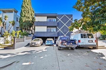 Los Angeles apartment for rent - A modern house with a white and black exterior and a white van parked in front.