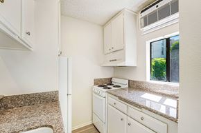 West Hollywood apartment for rent - A small kitchen with a stove and a window.