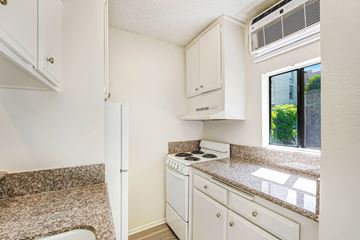 West Hollywood apartment for rent - A small kitchen with a stove and a window.