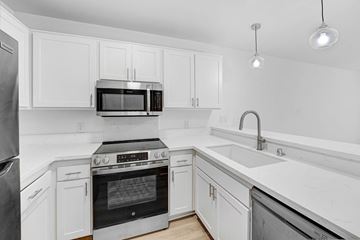 Santa Monica apartment for rent - A modern kitchen with white cabinets and stainless steel appliances.