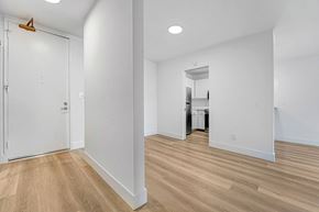 Santa Monica apartment for rent - A white room with a wooden floor and a white door.