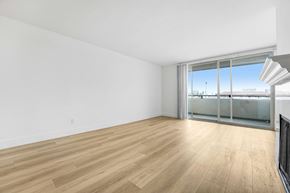 Santa Monica apartment for rent - A room with wooden flooring and a large window with a view of the outside.
