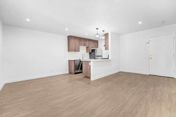 Hollywood apartment for rent - A kitchen area with a refrigerator, sink, and cabinets.