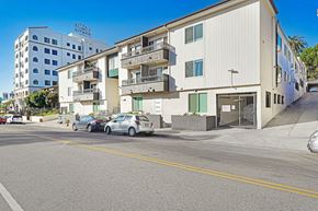 Hollywood apartment for rent - A street view of a residential area with cars parked on the side of the road.