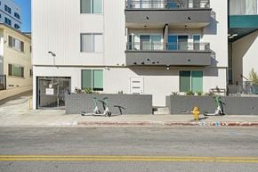Hollywood apartment for rent - A white building with a yellow fire hydrant in front of it.