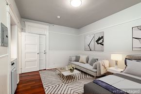 San Francisco apartment for rent - A bedroom with a bed, couch, and a striped rug.