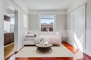 San Francisco apartment for rent - A living room with a couch, a coffee table, and a window.
