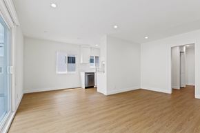 Santa Monica apartment for rent - A spacious room with wooden floors and white walls.