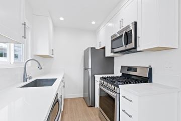 Santa Monica apartment for rent - A modern kitchen with white cabinets and stainless steel appliances.