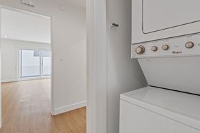 Santa Monica apartment for rent - A white Whirlpool oven sits in a kitchen with a wooden floor and white walls.