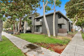 Los Angeles apartment for rent - A tree-lined street with apartment buildings on either side.