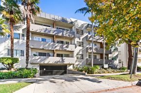 Los Angeles apartment for rent - A modern apartment building with a palm tree in front.