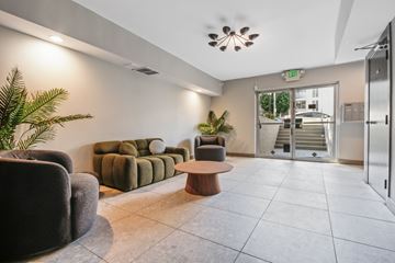 Los Angeles apartment for rent - A living room with a couch, chair, and potted plant.