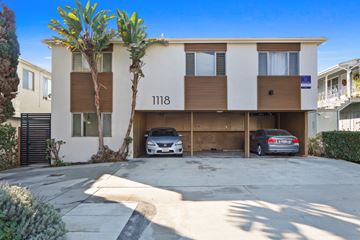 Santa Monica apartment for rent - A modern two-story apartment building with a garage and a car parked in front.