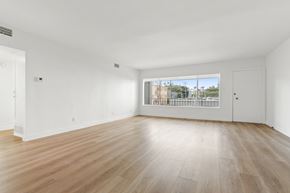 Santa Monica apartment for rent - A room with wooden flooring and white walls.