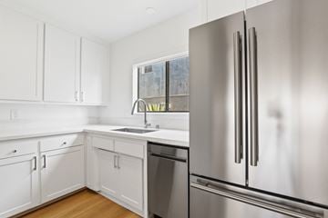 Santa Monica apartment for rent - A modern kitchen with a stainless steel refrigerator and white cabinets.