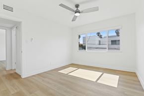 Santa Monica apartment for rent - A room with a ceiling fan and a window overlooking a building.