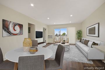 West Hollywood apartment for rent - A modern living room with a white table and grey chairs.
