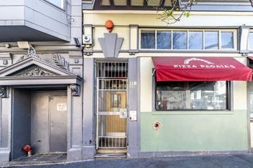 San Francisco apartment for rent - A building with a red awning that says PIZZA PAGAS.