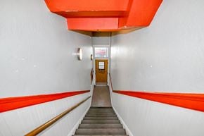 San Francisco apartment for rent - A stairway with a red handrail and white walls.