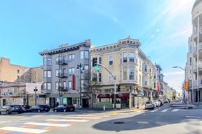 San Francisco apartment for rent - A street view of a city with buildings on both sides and cars parked on the side of the road.