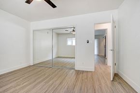 Los Angeles apartment for rent - A room with a sliding door and a ceiling fan.