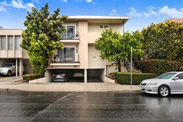 Los Angeles apartment for rent - A two-story beige house with a balcony on the second floor.