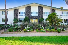 Los Angeles apartment for rent - A building with a green lawn in front of it.