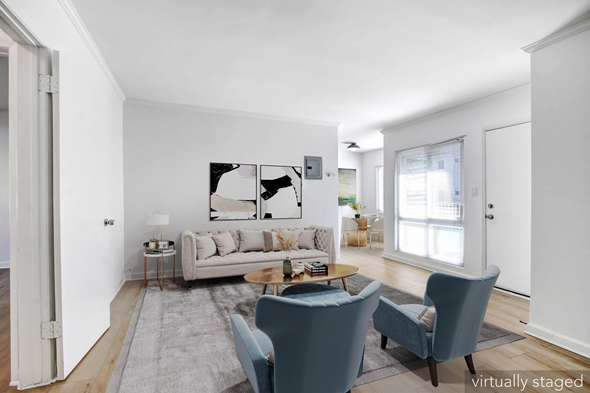 Los Angeles apartment for rent - A living room with a grey couch, a grey rug, a grey chair and a painting on the wall.