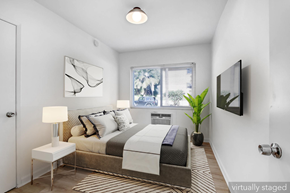 Los Angeles apartment for rent - A bedroom with a bed, nightstand, lamp, and a window.