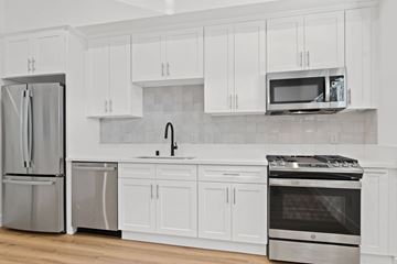 Santa Monica apartment for rent - A kitchen with white cabinets and stainless steel appliances.
