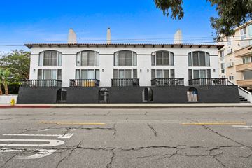 Marina Del Rey apartment for rent - A white building with black railings and a fire hydrant in front.