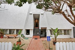 Marina Del Rey apartment for rent - A white building with a tree in front of it.