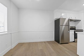Redondo Beach apartment for rent - A kitchen with a stainless steel refrigerator and wooden flooring.